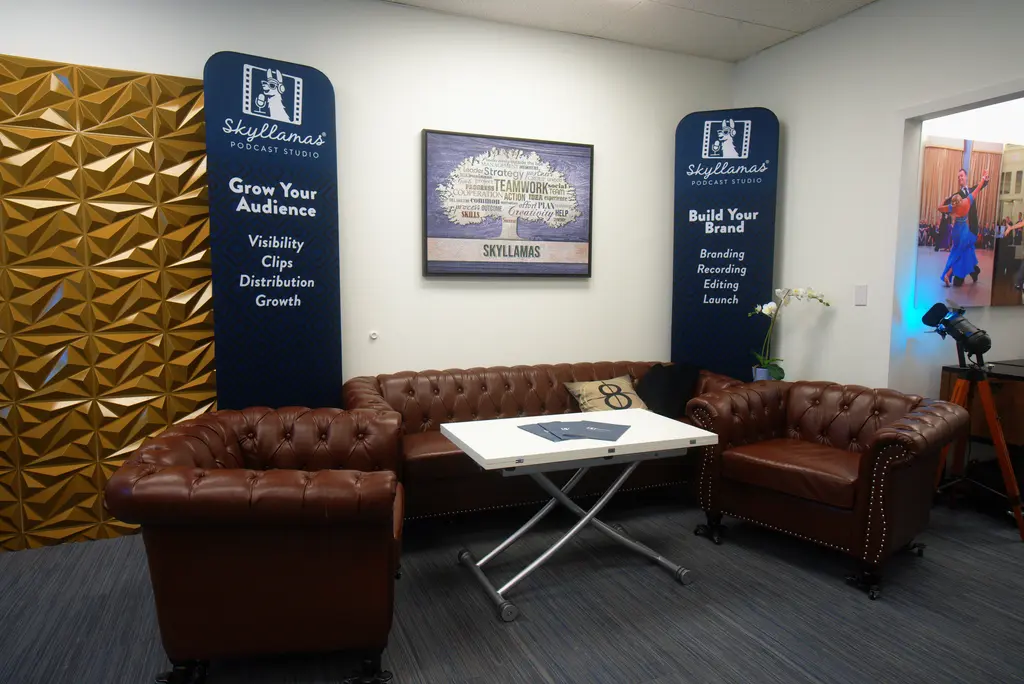The green room lounge with leather couches and Skyllamas Podcast Studio banners